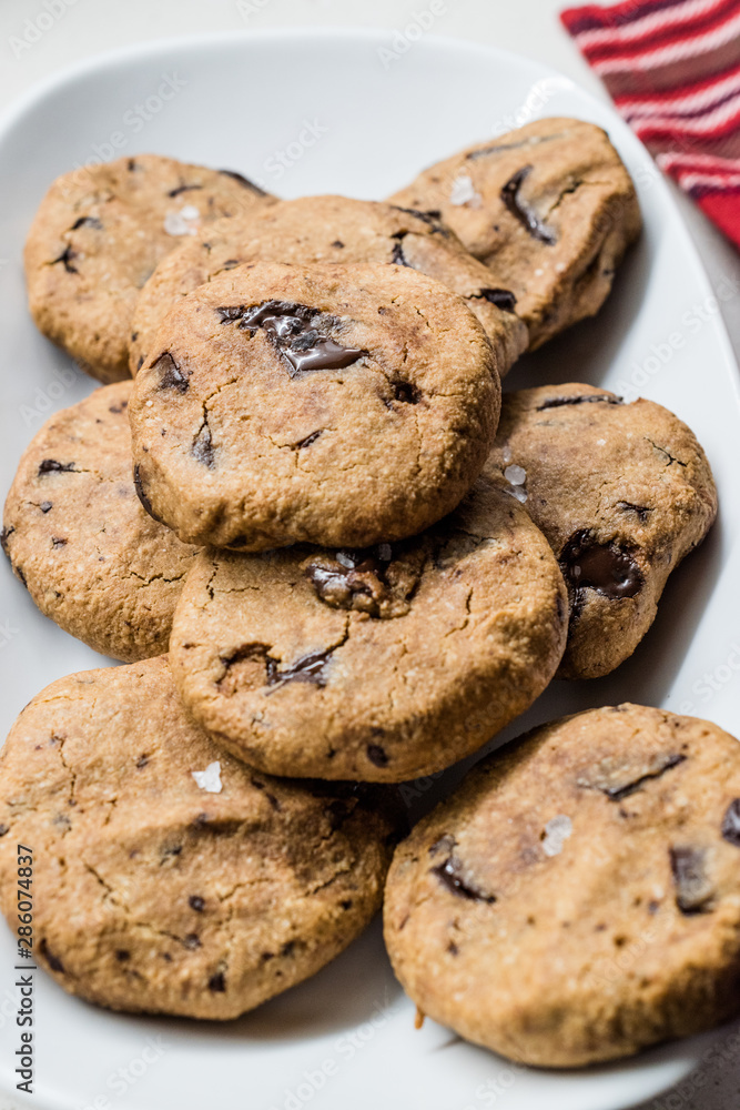 Paleo Chocolate Chip Cookies Made with Coconut and Almond Flour on Baking Sheet / Paper. Paleo Chocolate Chip Cookies Made with Coconut and Almond Flour on Baking Sheet / Paper.