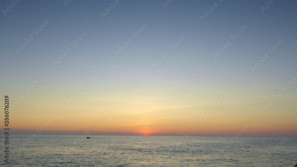 Paorama of a sea during beautiful sunset with small longtail boat silhouette and flying birds Paorama of a sea during beautiful sunset with small longtail boat silhouette and flying birds