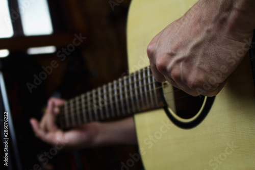 Acoustic Guitar Player Performing. Guitarist Playing In Music Studio