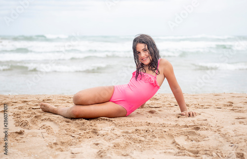 Little pretty girl on the shore of the beach