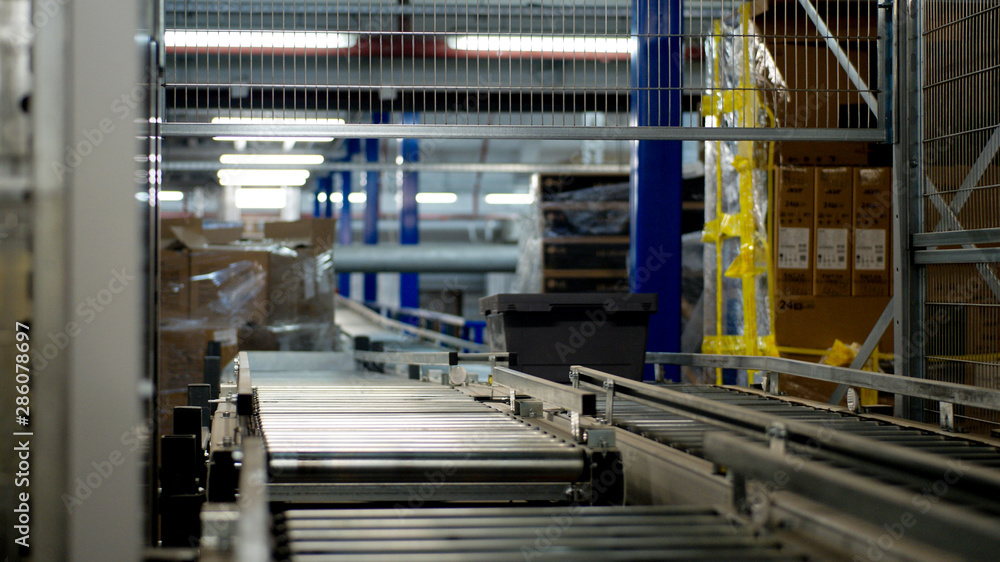 Plastic Box moving on conveyor belt in Distribution Warehouse