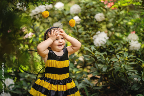 portrait of amazed excited little girl doesn't believe her success, keeps hands on head, stares at camera, says omg or wow.