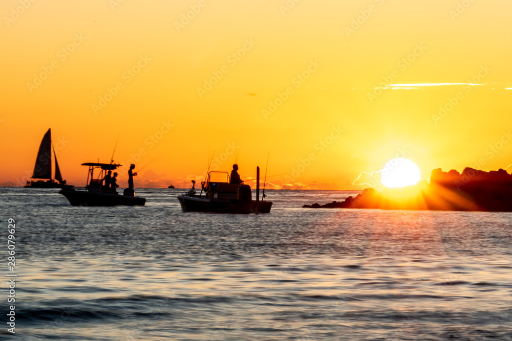 Silhouette of fishermen on the Gulf of Mexico at sunset