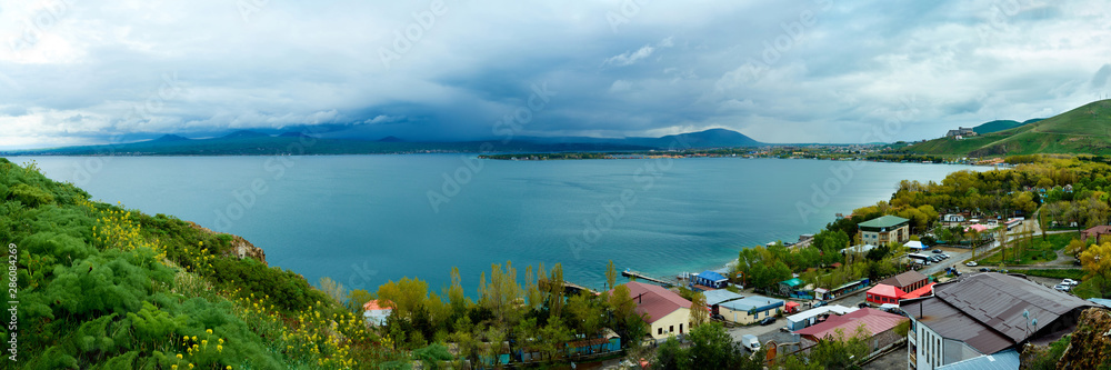 the endless water expanses of the lake Sevan on a cloudy day with clouds in the sky.