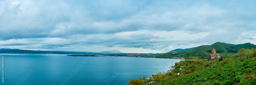 the endless water expanses of the lake Sevan on a cloudy day with clouds in the sky.