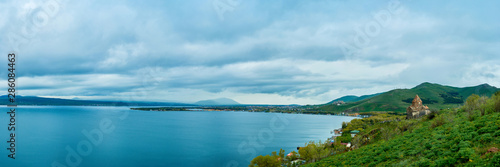 the endless water expanses of the lake Sevan on a cloudy day with clouds in the sky.