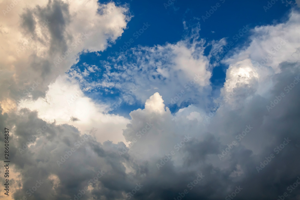 Cumulus clouds gather before the rain against a clear blue sky. Natural landscape. Cumulus clouds gather before the rain against a clear blue sky. Natural landscape.