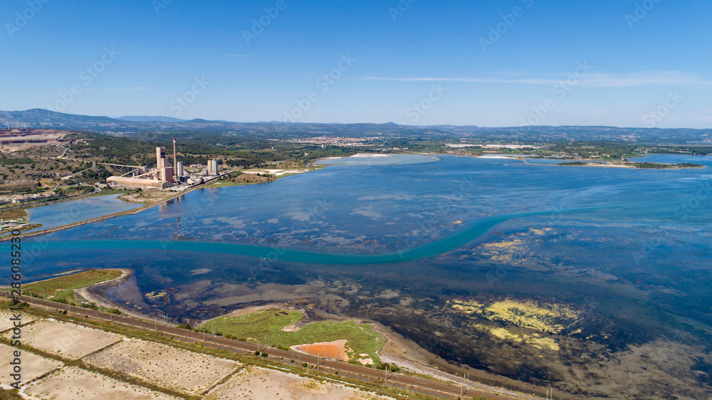 Aerial photo of a cement factory along the Berre lake in Port La Nouvelle