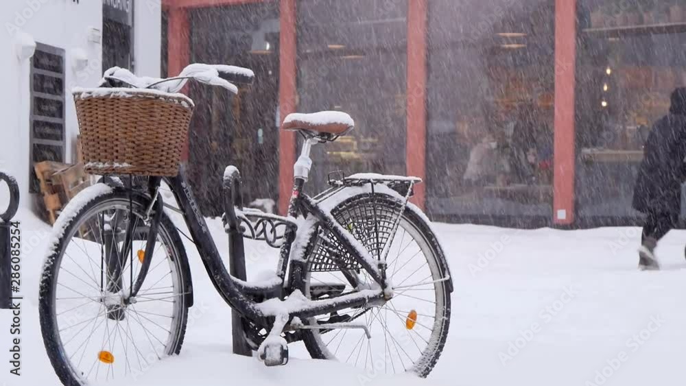 City Bicycle With A Shopping Cart Standing On The Street During Snowfall City Bicycle With A Shopping Cart Standing On The Street During Snowfall