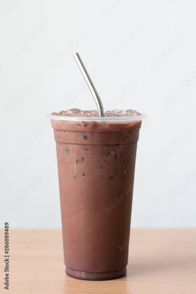 Close up reusable stainless steel straw with iced chocolate on white background. Close up reusable stainless steel straw with iced chocolate on white background.