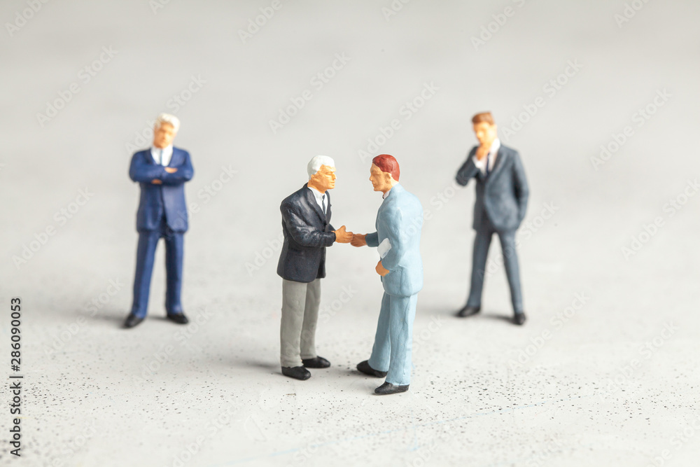 Businessmen in suits shake hands. Contract or successful deal concept. Businessmen in suits shake hands. Contract or successful deal concept.