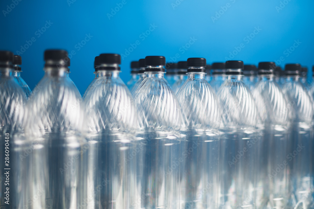 empty plastic bottles on blue background empty plastic bottles on blue background