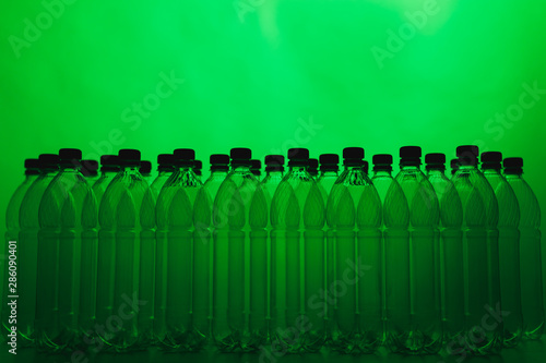 empty plastic bottle silhouettes on green background