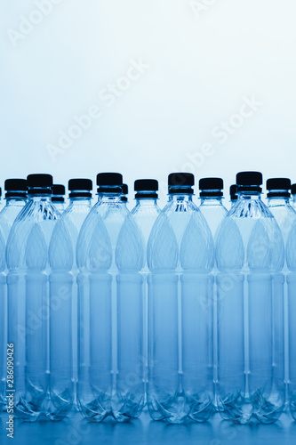 empty plastic bottle silhouettes on blue background