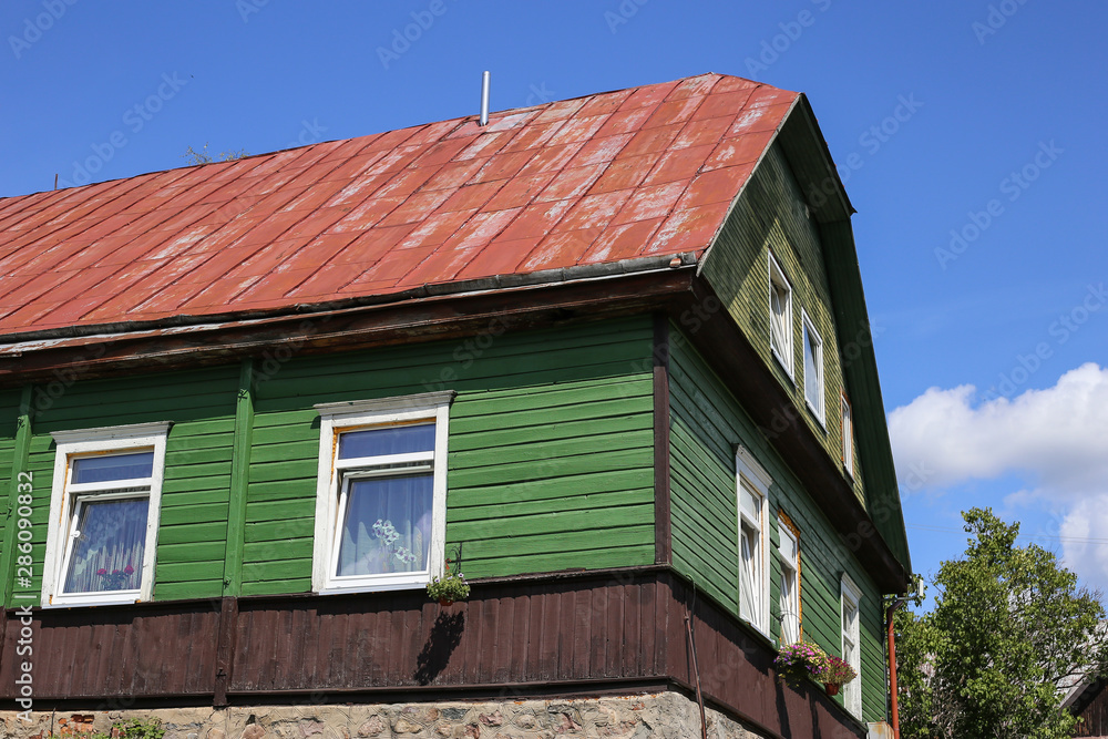 Typical house in Lithuania, Trakai. Antique old house with green old wood