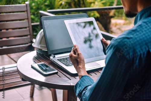 Businessman Holding Tablet mobile smart phone Notebook on table for work