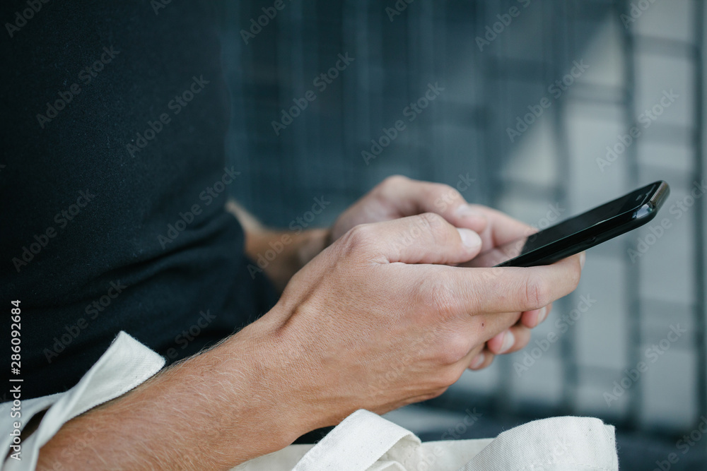Man holding a phone over dark background Man holding a phone over dark background
