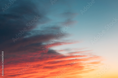 Beautiful sunset sunrise sky with pink orange and dark clouds. sky with colorful clouds © irissca