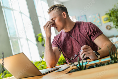 Young businessman with stress in the office