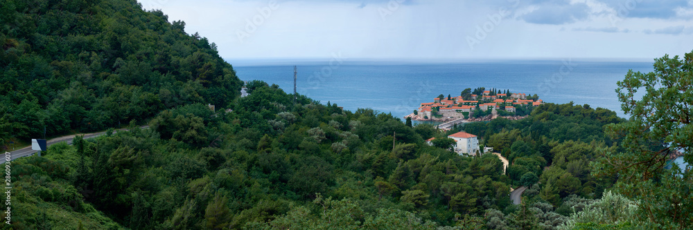 A view of Sveti Stefan from a height on an overcast day.