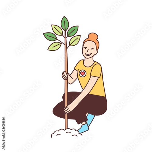 Young happy female volunteer or ecologist planting tree in park isolated on white background