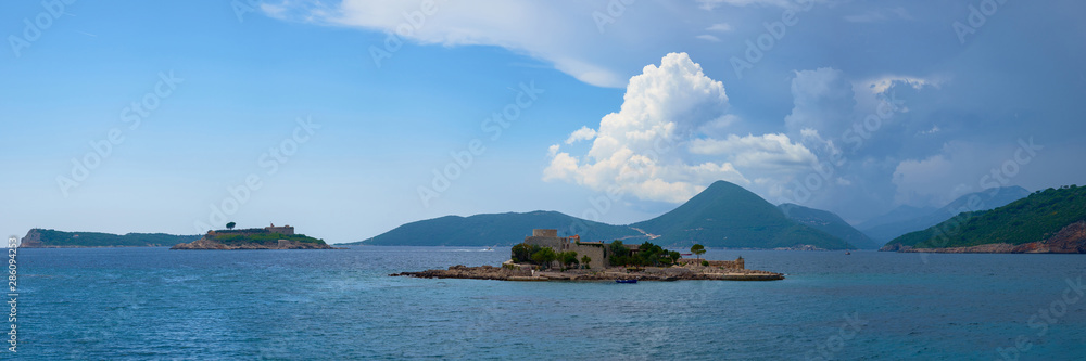 The fortress-island of Mamula on a sunny day near the ancient fortress Arza, a desert island in the Adriatic Sea, with clouds in the sky.
