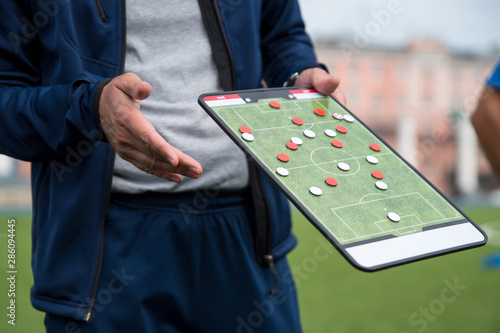 Football tactic education. Coach explains the strategy of the game