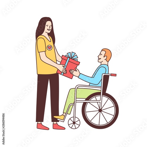 Cute female volunteer giving gift to disabled person in wheelchair isolated on white background