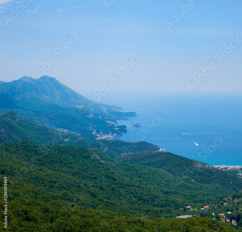 View of Boko Kotor on the background of mountains with clouds in the sky on a cloudy day.