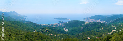 View of Boko Kotor on the background of mountains with clouds in the sky on a cloudy day.