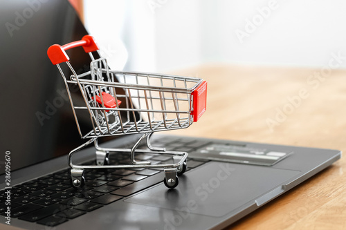 shopping cart and cradit card on laptop in office. concept shopping online