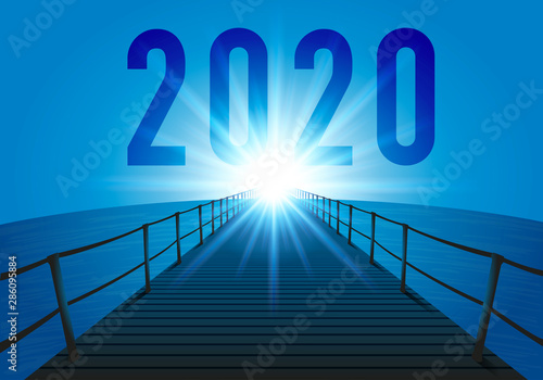 L’année 2020 avec le concept de l’objectif à atteindre, en prenant comme symbole un ponton au dessus de l’océan orienté vers les rayons du soleil qui pointent comme un repère à l’horizon.