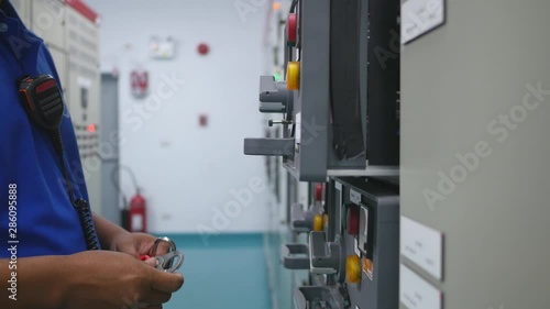 Engineer to use key lock out tag out (LOTO) for isolated power electrical system before maintenance equipment in factory , Safety and industrial concept photo