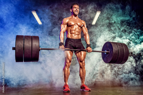 Strong Muscular Men Performing Heavy Deadlift Exercise With Barbells photo