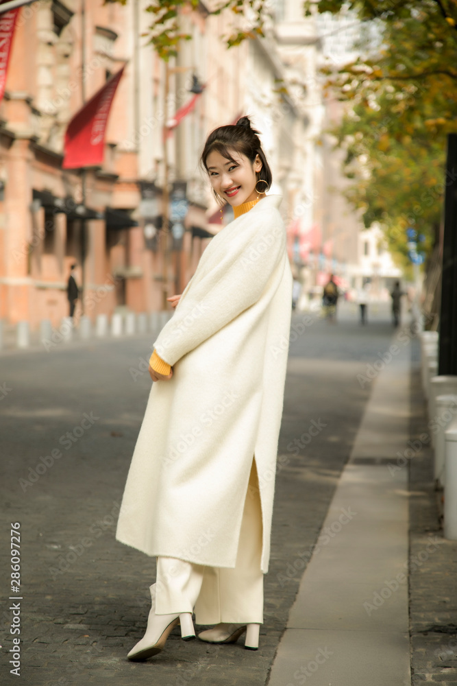 Asian girl in white coat