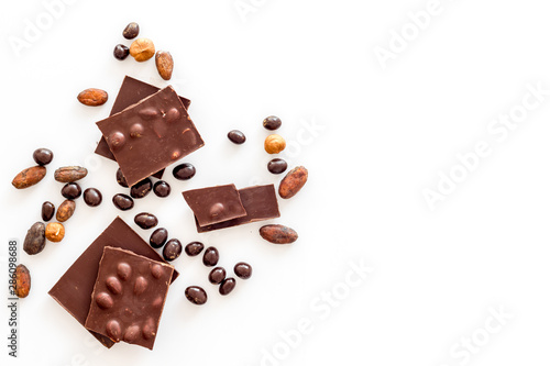Different variety of chocolate and hazelnut on white background top view space for text