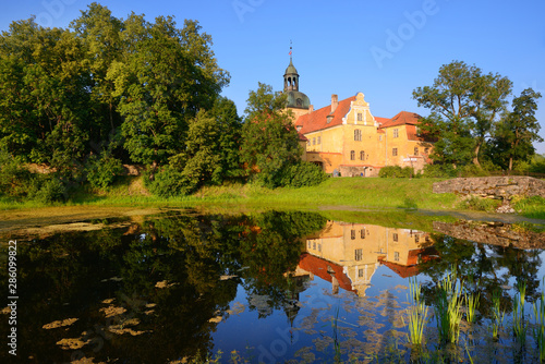 Straupe mansion reflecting in a park lake photo