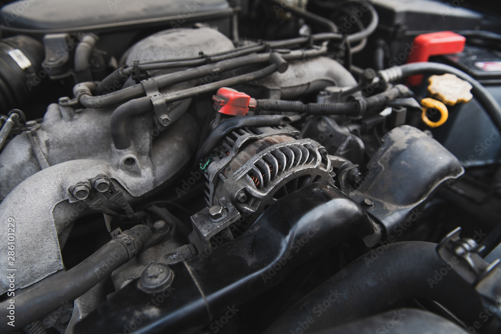 Dusty boxer engine under the hood. Generator and other parts of the motor.