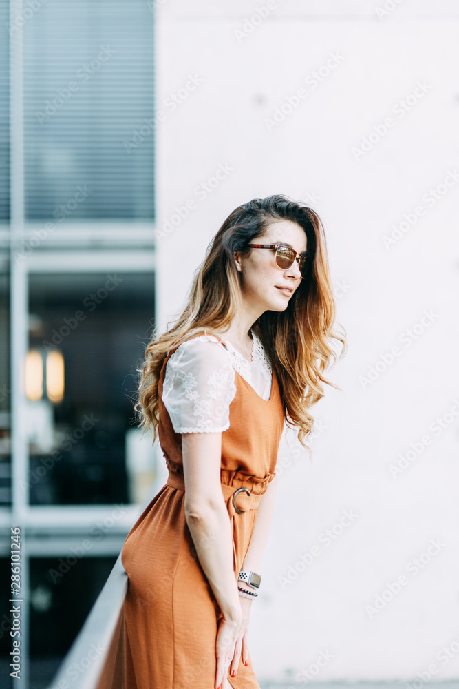 stylish image in the modern architecture of the building. a bright young girl in Berlin. stylish image in the modern architecture of the building. a bright young girl in Berlin.