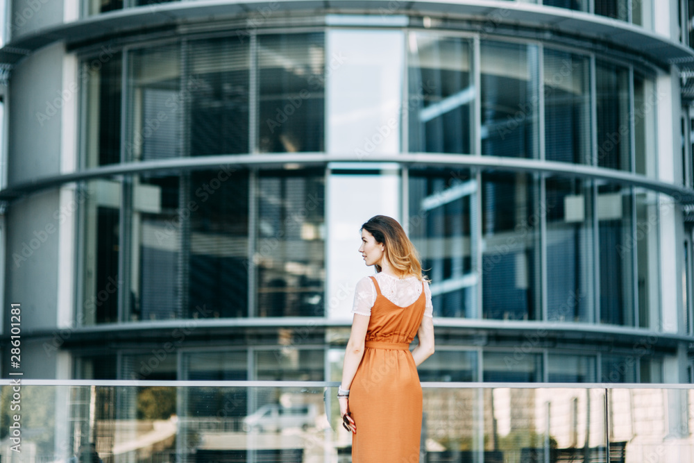 stylish image in the modern architecture of the building. a bright young girl in Berlin. stylish image in the modern architecture of the building. a bright young girl in Berlin.