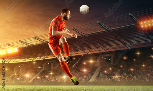 Soccer player in action on a field with the ball. Sports game. Soccer championship. Floodlit stadium