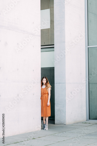 light portraits of a young girl on a white background. stylish image in the modern architecture of the building.