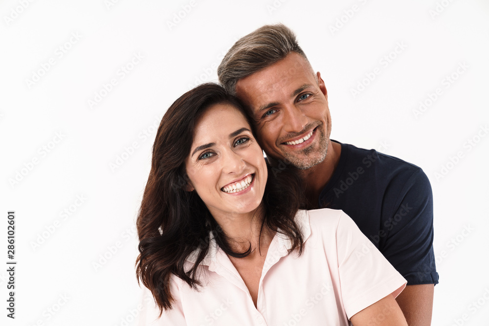 Cheerful couple wearing casual outfit standing isolated Cheerful couple wearing casual outfit standing isolated