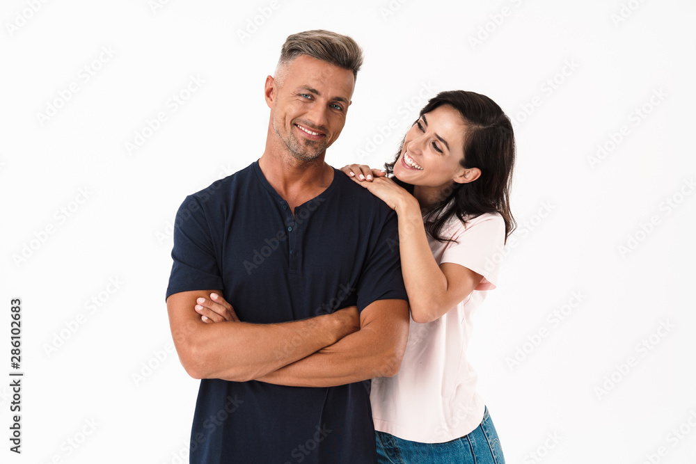 Cheerful couple wearing casual outfit standing isolated Cheerful couple wearing casual outfit standing isolated