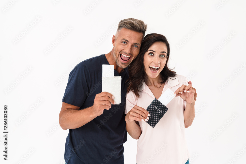 Cheerful couple wearing casual outfit standing isolated Cheerful couple wearing casual outfit standing isolated
