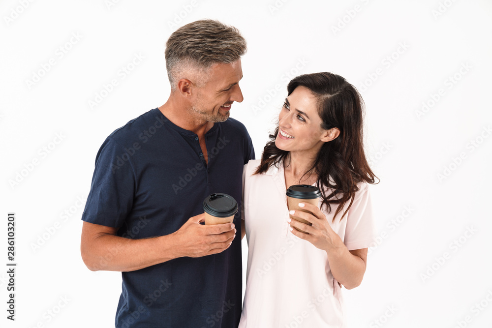 Cheerful couple wearing casual outfit standing isolated Cheerful couple wearing casual outfit standing isolated