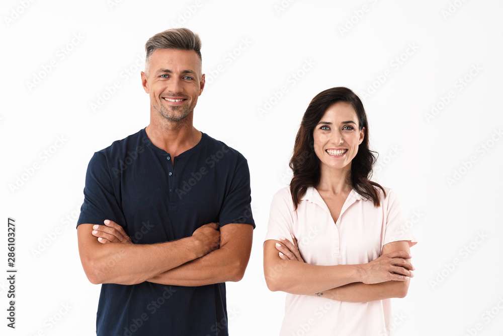 Cheerful couple wearing casual outfit standing isolated Cheerful couple wearing casual outfit standing isolated