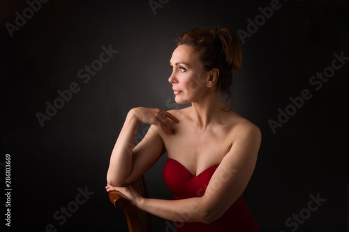 portrait of a sensual fifty year old woman on grey studio background