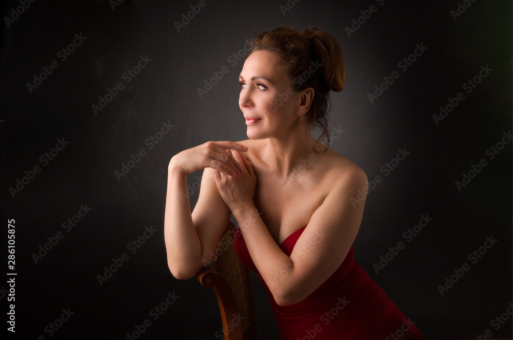 portrait of a sensual fifty year old woman on grey studio background portrait of a sensual fifty year old woman on grey studio background