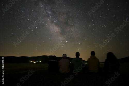 Photo of star in the night long exposure whit guys friends